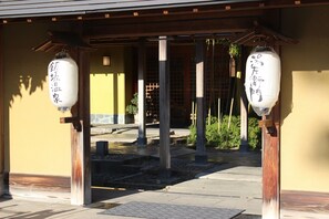 A traditional Japanese building entrance with wooden pillars and white paper lanterns. - Matsuriya Yuzaemon (Fukushima)