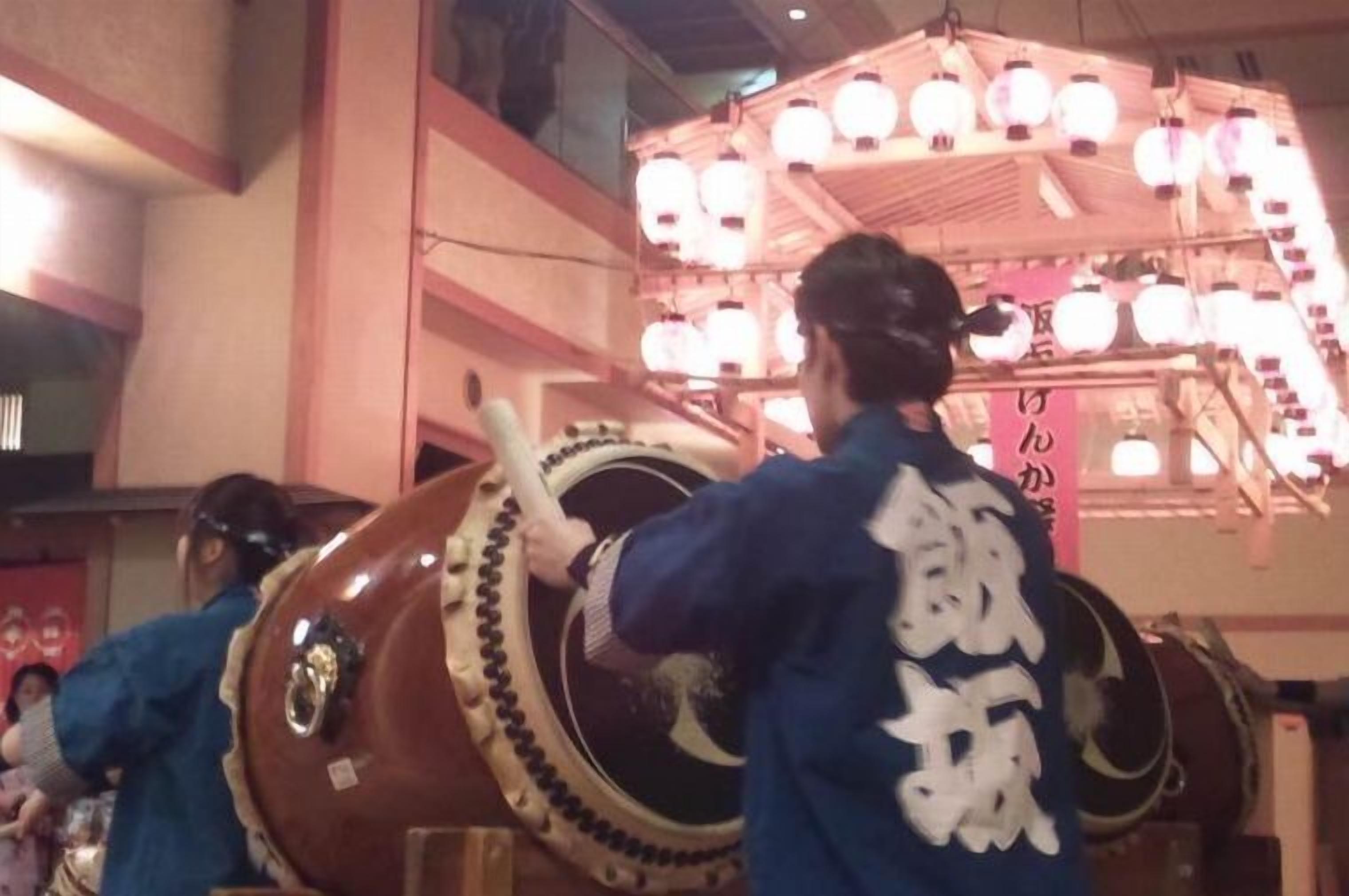 A traditional Japanese drum with a person playing it.