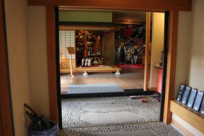 A traditional Japanese interior with tatami mats, a shoji screen, and a wooden bench. - Matsuriya Yuzaemon (Fukushima)