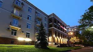 A multi-story hotel with balconies, a well-lit entrance, and a paved courtyard. - Hotel Oberig Kiev (Kyiv)