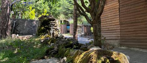 A stone pathway leading to a wooden building with a rustic exterior.