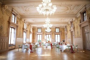 A grand hall with ornate ceiling, chandeliers, and multiple tables set for dining. - Grand Hôtel des Bains de Lavey (Lavey-Morcles)