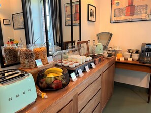A breakfast buffet with various food items, a coffee machine, and a toaster. - La Récréation (Chatelaudren)
