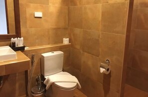 A small, modern bathroom with a toilet, bidet, and a sink. - Nan Green Lake View Resort (Nan)