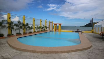 Outdoor pool, open 7 AM to 10 PM, pool umbrellas