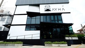 Un bâtiment moderne, doté d’un logo bien visible et du nom « AYHA » sur la façade.