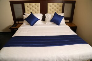 A hotel room with a large bed, two nightstands, a telephone, and a window with blinds. - Dr. Rajkumar International Hotel (Bengaluru)