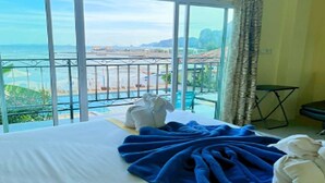 A hotel room with a large window offering a view of the beach and ocean. - Anyavee Nam Mao Beach Resort (Krabi)