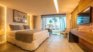 A modern hotel room with a large bed, a wooden vanity, a television, and a view of the outdoors. - Pedras Do Patacho Hotel Boutique Experience (Porto de Pedras)
