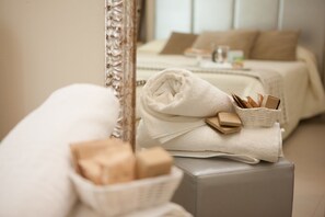 A neatly arranged bathroom with a white towel, toiletries, and a mirror. - Hotel Darsena (Riccione)