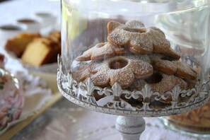 A glass display case filled with cookies, possibly for sale or display.