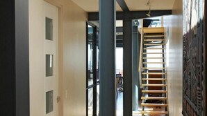A hallway with wooden flooring, a staircase, and a ceiling with skylights. - 46 Loader De Waterkant (Cape Town)