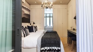 Ein Schlafzimmer mit einem Bett, einem Schreibtisch und einem Fenster.
