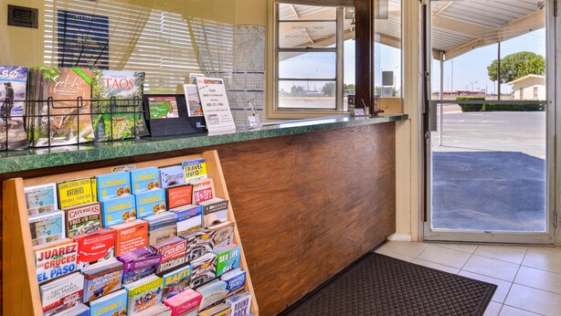 A reception desk with a wooden counter, a map, and various brochures.