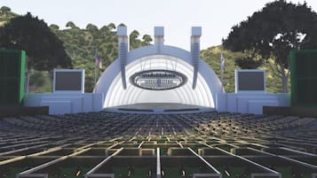 A large, modern auditorium with tiered seating and a central stage.