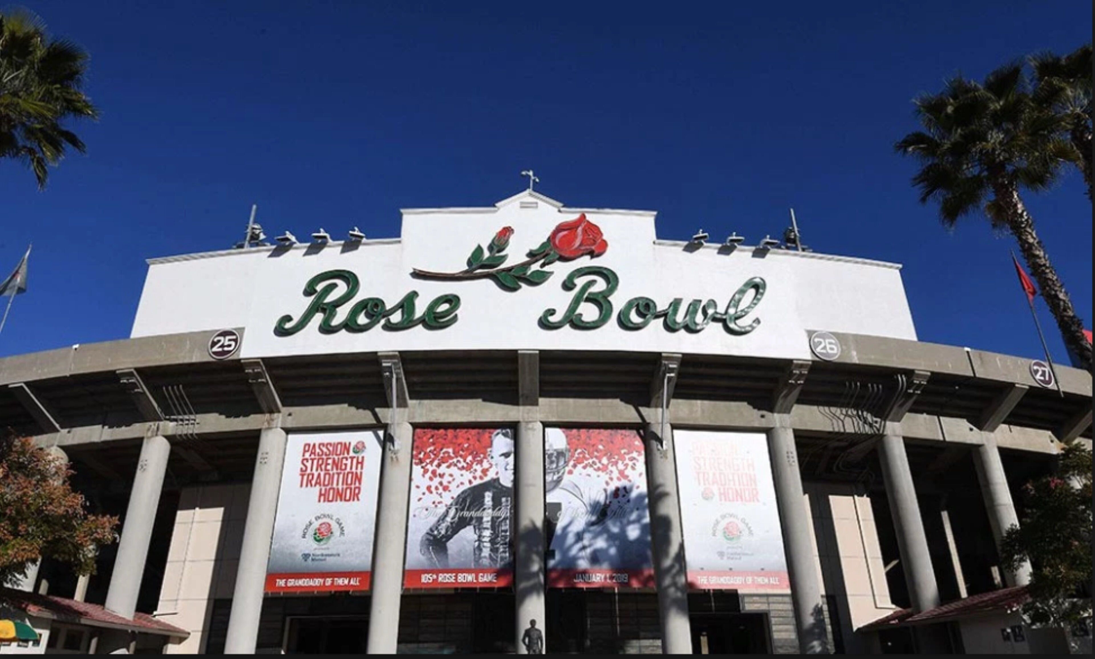 A stadium with the 'Rose Bowl' sign, featuring large columns and banners.