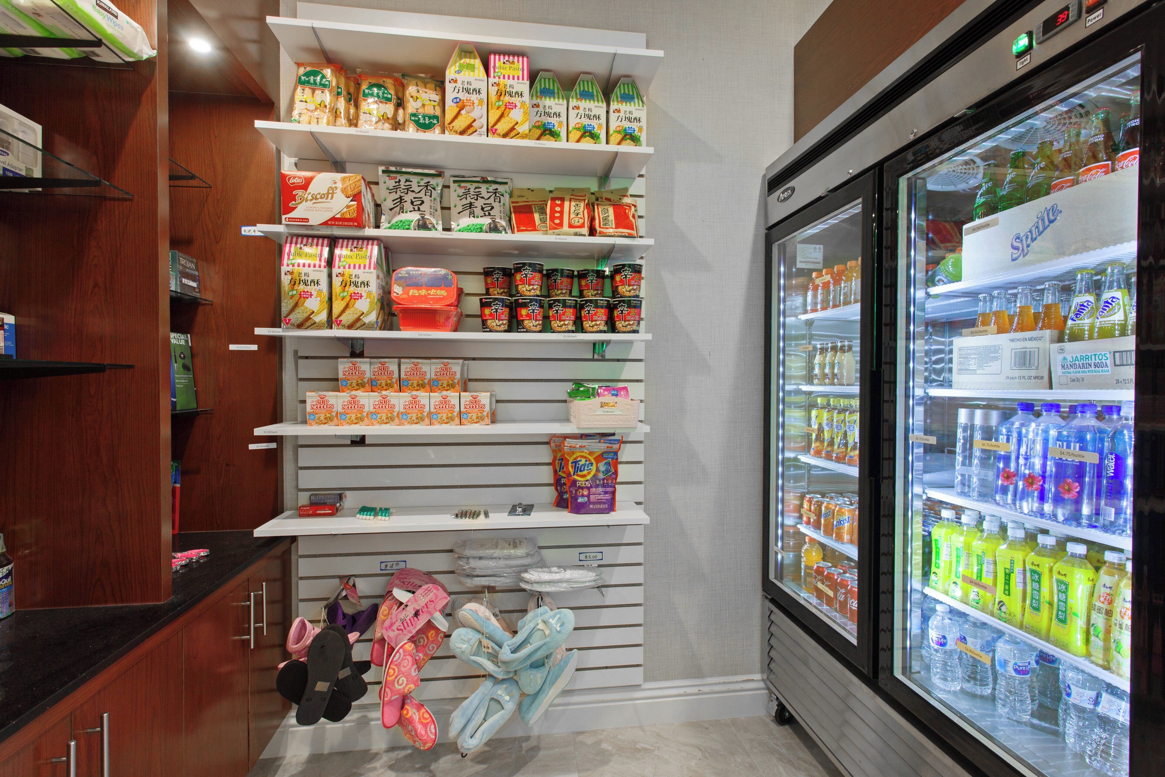 A refrigerated beverage display with various drinks and a freezer section.