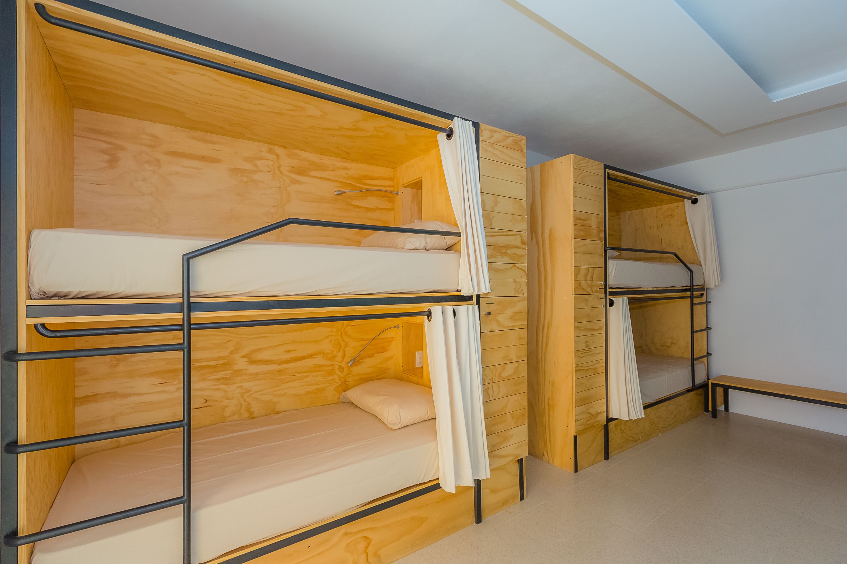 A room with bunk beds and a wooden interior.