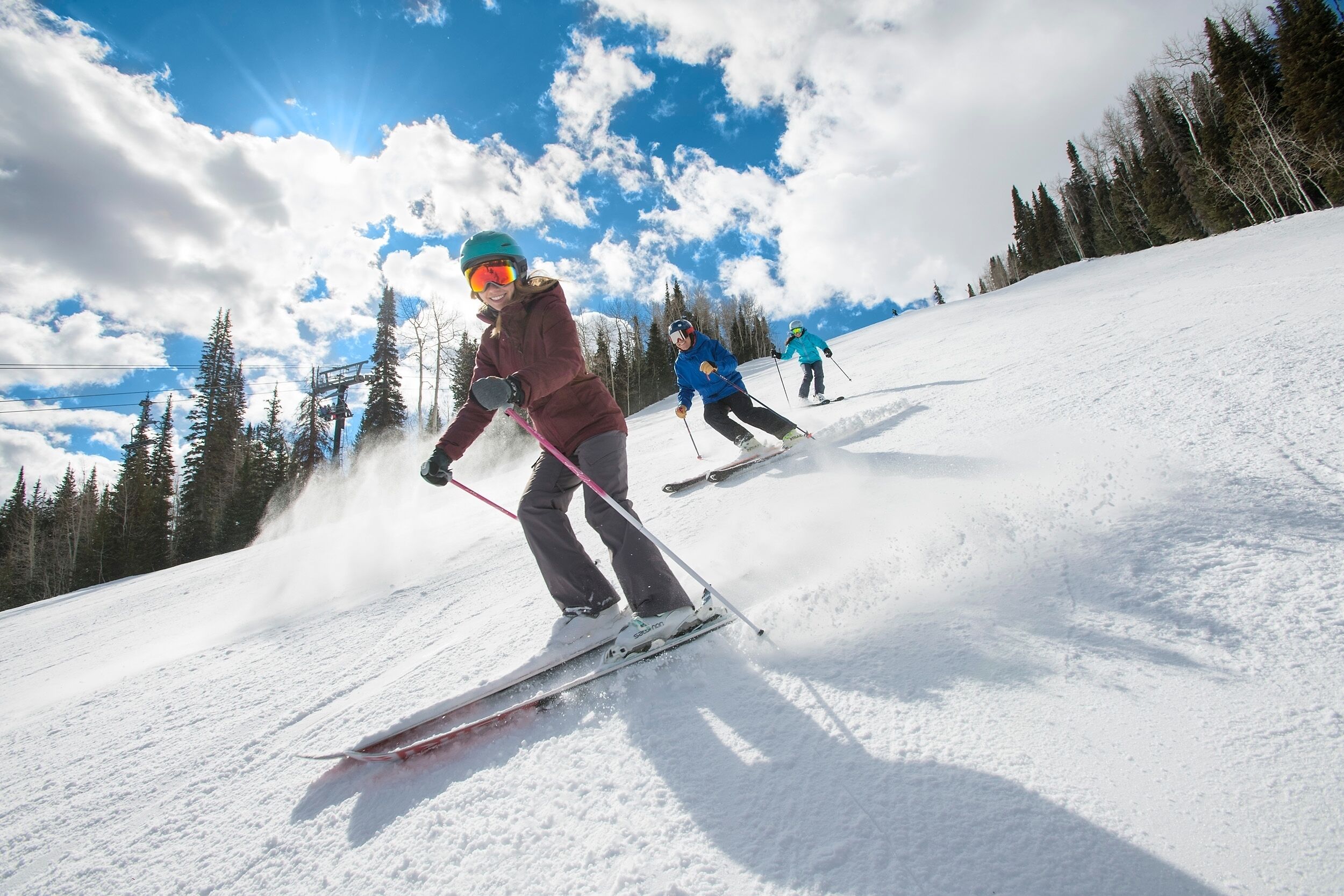 A ski slope with skiers descending.