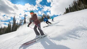 A ski slope with skiers descending.