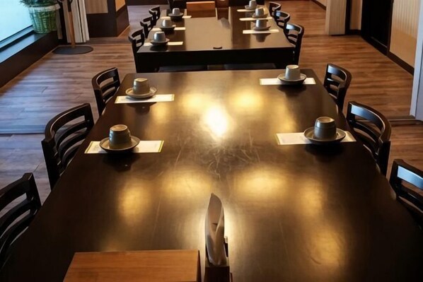 A dining area with tables set for four, each with a plate, cup, and napkin. - Hotel Noblesse (Seoul)