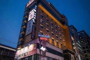 A multi-story hotel with illuminated signage, including a prominent 'HOTEL' sign. - Hotel Noblesse (Seoul)