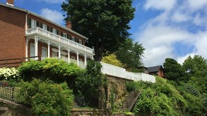 A large brick building with a white porch and a large tree in front. - View from Quality Hill overlooking historic district, quick walk to downtown (Galena)