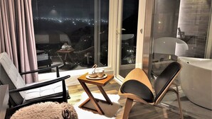 Un salon moderne avec un canapé, un fauteuil, une petite table et un tapis moelleux.