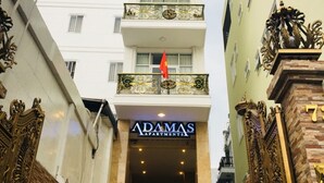 A building with a sign reading "ADAMAS APARTMENTS" at the entrance. - Adamas Apartment (Ho Chi Minh City)