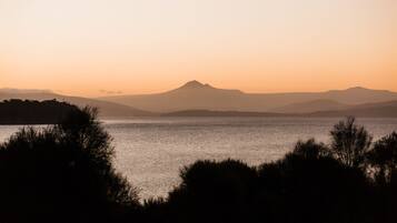 A serene lakeside view with a mountain in the background.