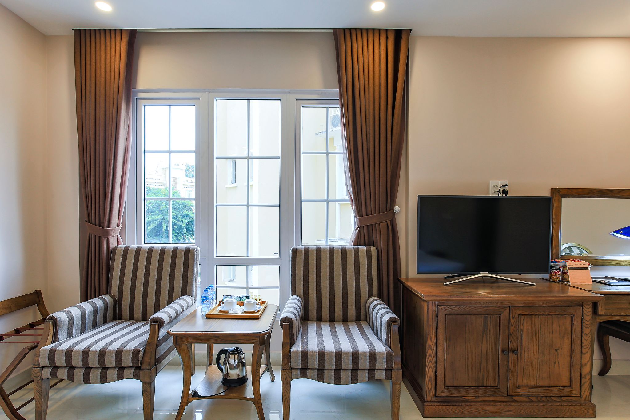 deluxe triple room | living area | lcd tv