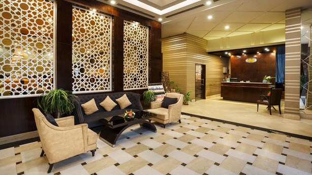A lobby with a reception desk, a sofa, and a coffee table.
