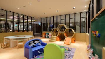 Explore a vibrant play area with playhouses, climbing structures, and building blocks.