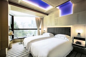 A hotel room with two beds, a large window with curtains, a city view, and a modern design. - The Emperor Hotel (Hong Kong)
