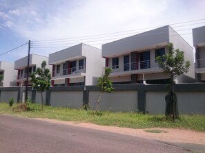 A modern multi-story residential building with balconies, a grey exterior, and a clear sky. - Lifestyle Apartments (Gaborone)