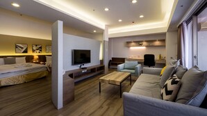 A modern hotel room with a bed, sofa, TV, and a small kitchen area. - Sky19 Hotel (Taipei)