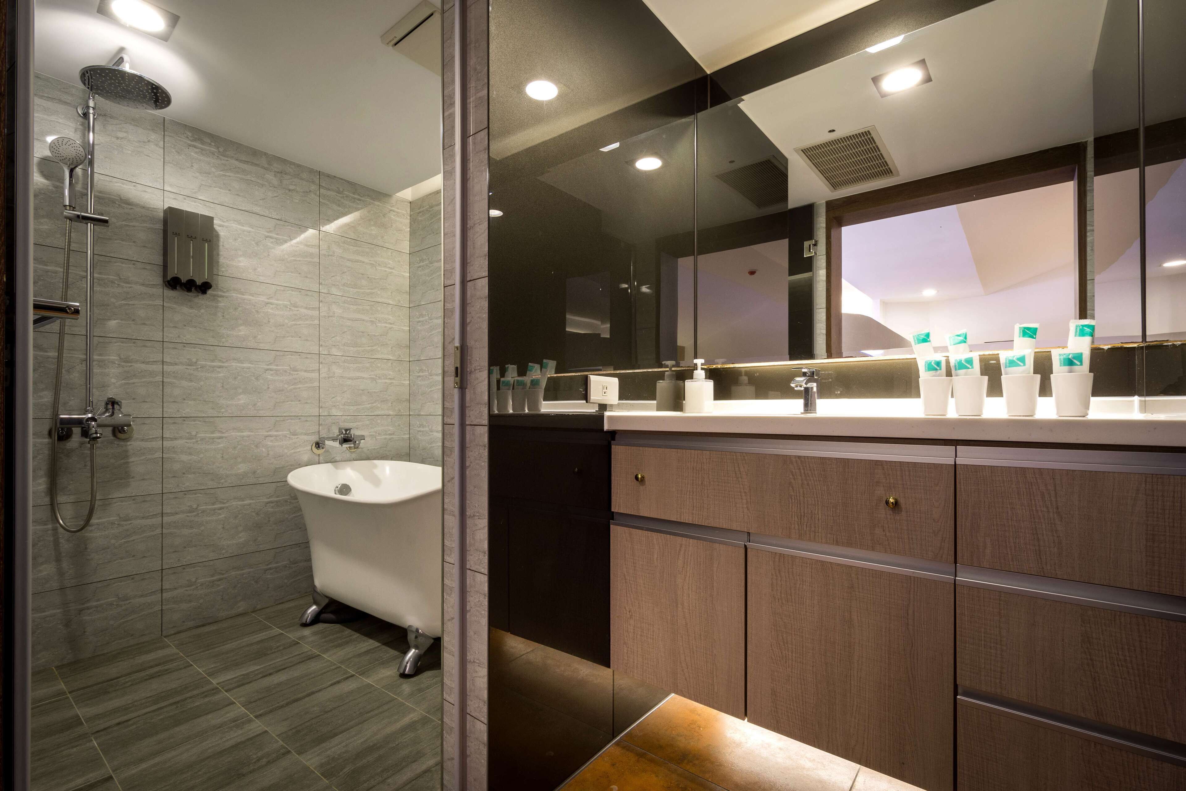 deluxe city view family room | bathroom | shower, hair dryer, slippers, bidet