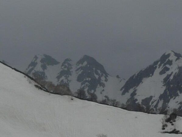 A snow-covered mountain with a clear sky.