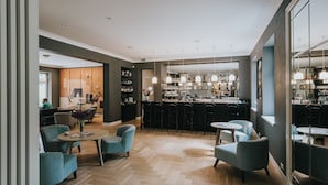 A modern bar area with seating and a bar counter. - Villa Santa Hotel (Cesis)