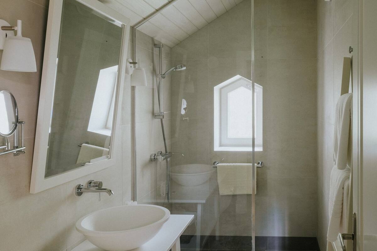 superior deluxe room | bathroom | shower, free toiletries, hair dryer, slippers