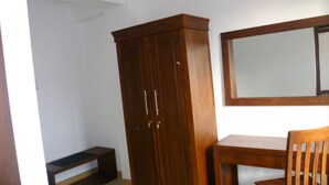 A room with a wooden wardrobe, a mirror, and a wooden desk. - Sarvodaya Samma Vaasa Resedence (Kandy)