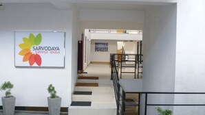A staircase with a sign reading "SARVODAYA Sanna Vaasa" on the wall. - Sarvodaya Samma Vaasa Resedence (Kandy)