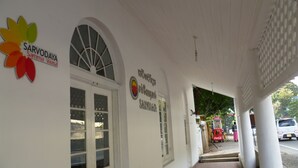 A building entrance with a Coca-Cola vending machine and a parked car outside. - Sarvodaya Samma Vaasa Resedence (Kandy)
