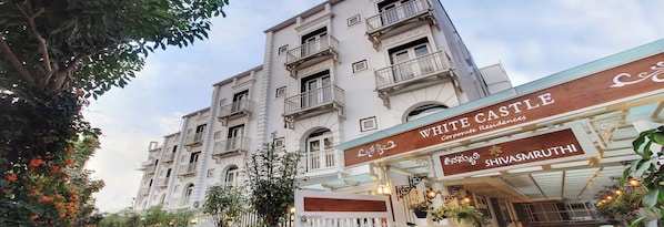 A multi-story building with balconies and a sign for "WHITE CASTLE Corporate Residences."