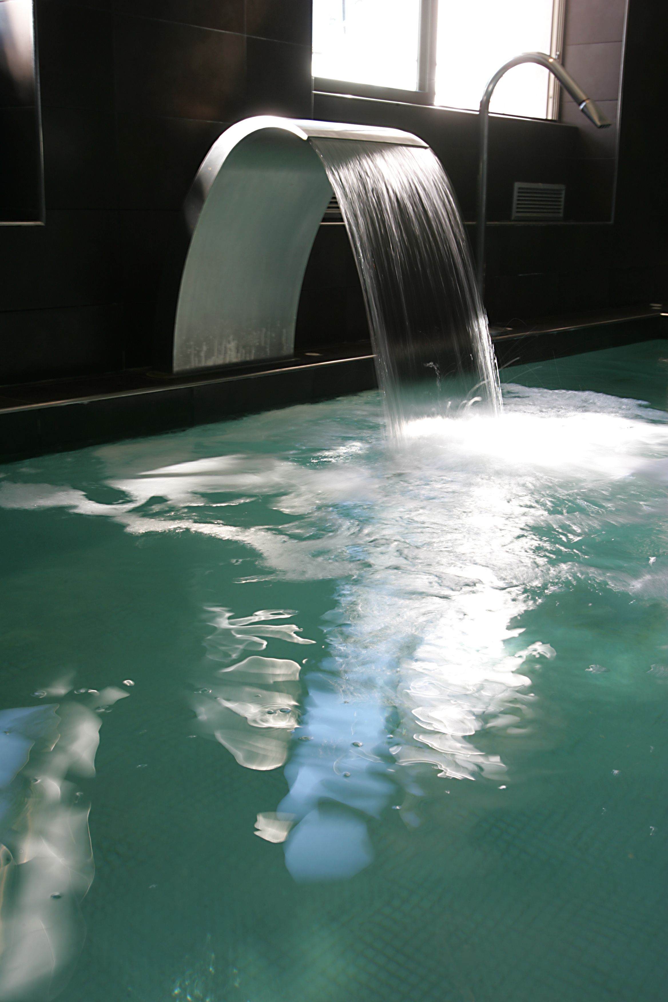 A pool with a waterfall feature.
