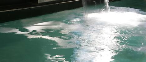 A pool with a waterfall feature.