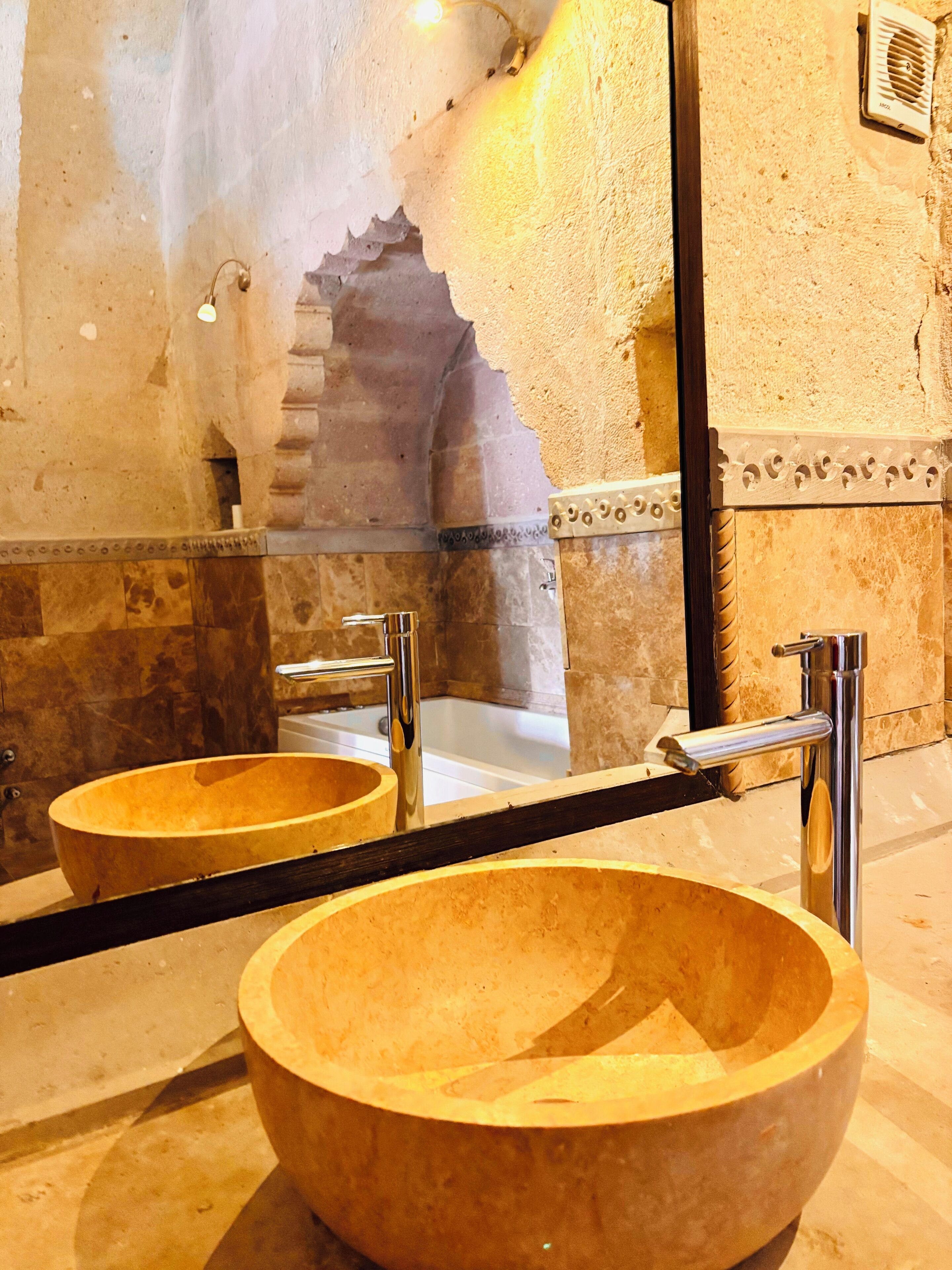A bathroom with two wooden sinks, a mirror, and a bathtub.