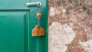 A green door with a metal handle and a keyhole.