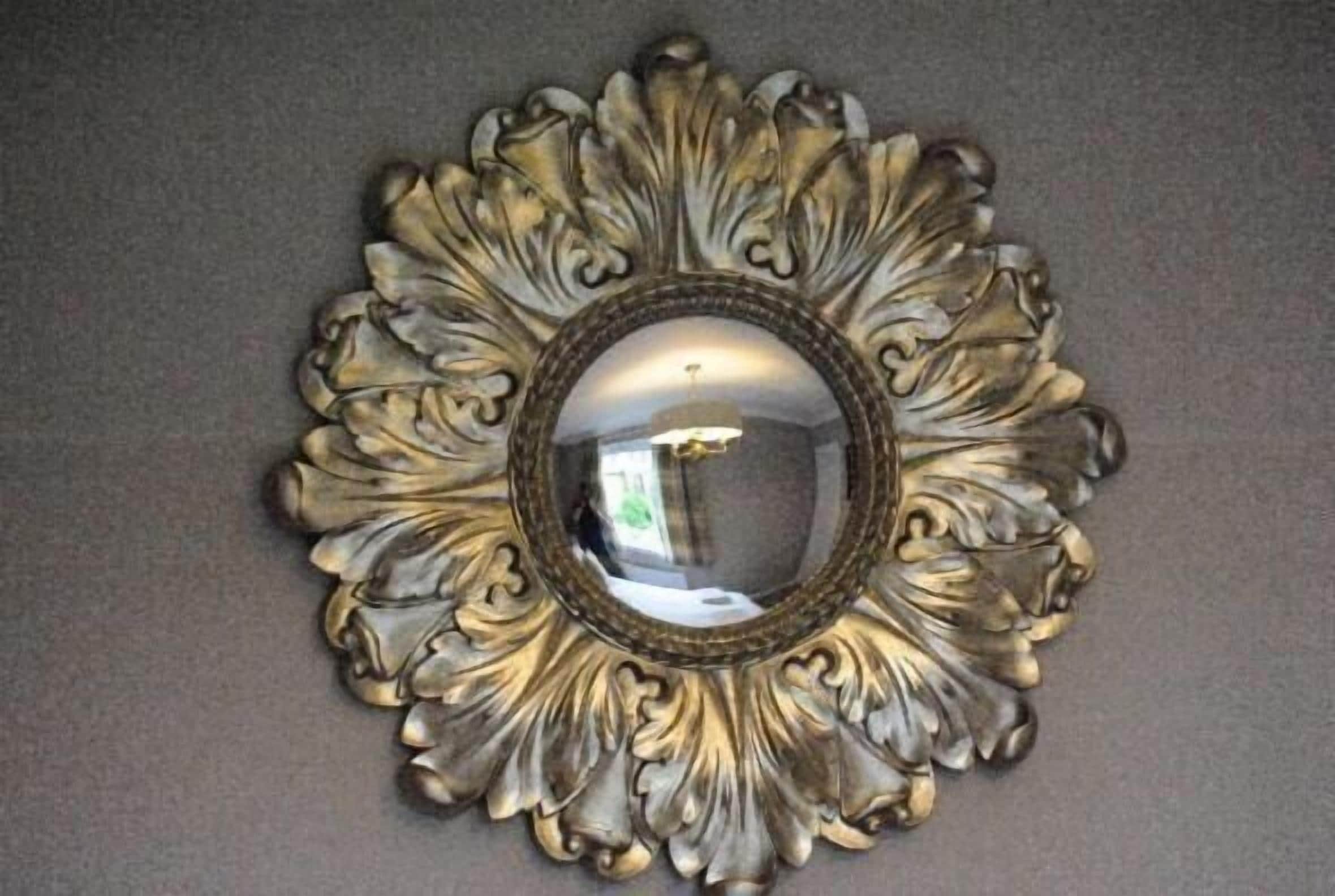 A decorative mirror with an ornate frame.