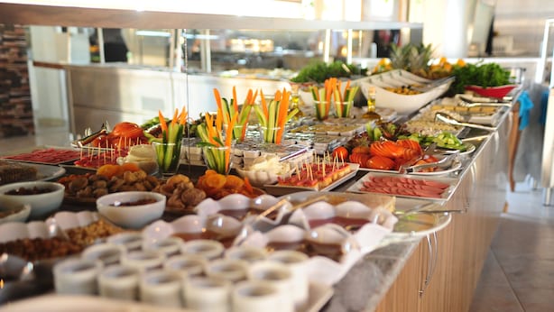 A buffet with various food items and utensils. - Usak Yucel Hotel (Usak)